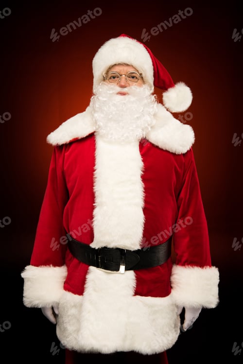 Preview: Santa Claus standing and looking at camera on dark