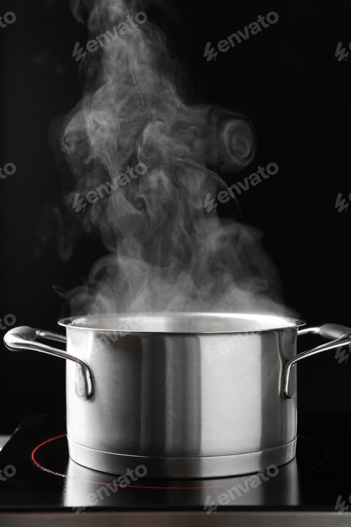 Preview: Steam rising from cooking pot and stove on black background, closeup
