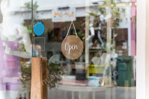 Preview: A business sign that says ‘Open’ on local businesses hang on door at entrance.