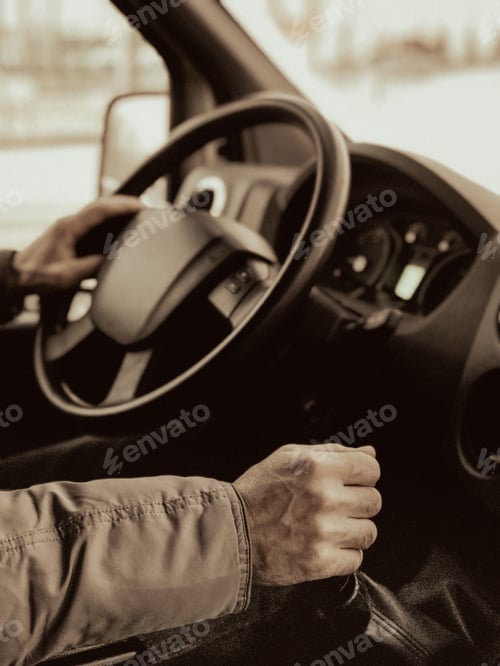 Preview: A man is driving a truck. Close-up. A man's hand switches the gear lever