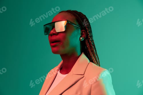 Preview: African american woman smile and fashion wearing glasses green background in neon light color mixed