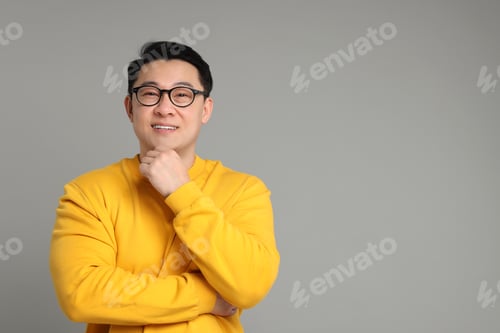 Preview: Portrait of happy man on grey background. Space for text