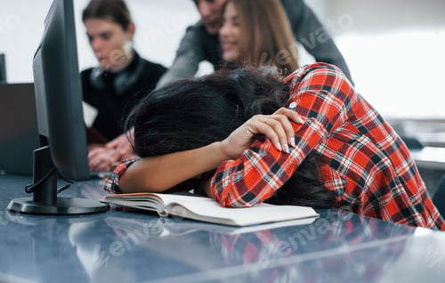 Preview: Need some sleep. Group of young people in casual clothes working in the modern office