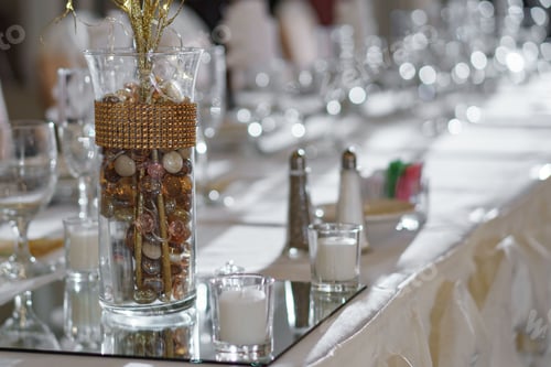 Preview: Closeup shot of a jar of colorful beads as a decoration on a wedding table