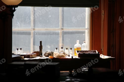 Preview: Vintage scientist desk with samples chemical solutions & elements used for science experiments.