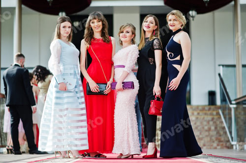 Preview: Fantastic young women in awesome fashionable dresses posing in the restaurant.