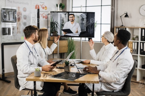 Preview: Diverse doctors having video call with colleague at clinic