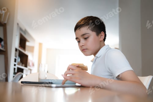 Preview: Asian Child using tablet computer Ai technology for homework,Schoolboy watching online playing game