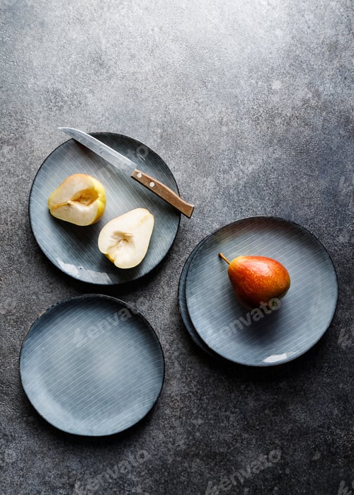 Preview: Blue food ceramic set with plates and pears over grey textured background