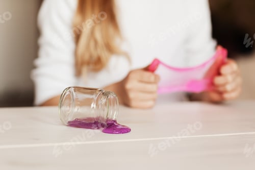 Preview: The child is holding a toy called mucus, the child is having fun and experimenting
