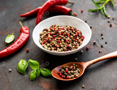 Preview: Red hot chili pepper corns and pods on dark background, top view