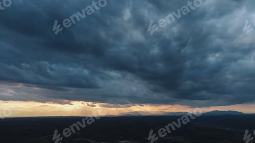 Preview: Aerial shot of the cloudy dark sky during the dawn