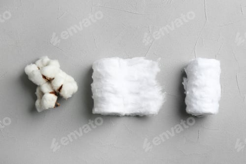 Preview: Flat lay composition with cotton rolls and flowers on grey stone background