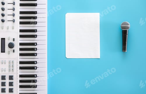 Preview: Musical keys, microphone and blank paper on a blue background.