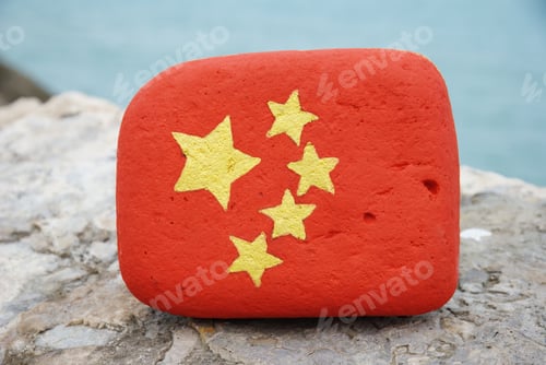 Preview: China flag hand painted on a stone with sea background