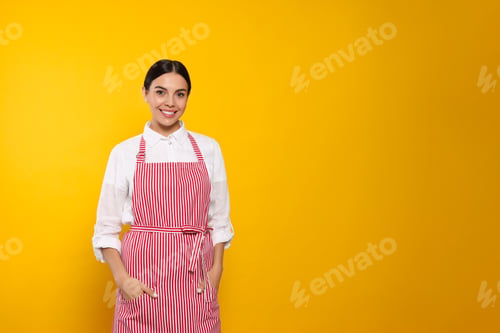 Preview: Young woman in red striped apron on yellow background, space for text