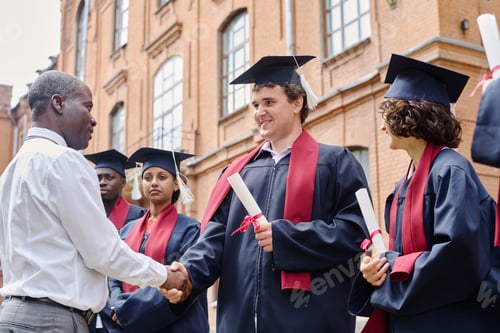 Preview: Teacher congratulating students with graduation of university