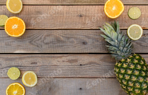 Preview: Top view of the collection of fresh lime, lemon, orange and pineapple on wooden background