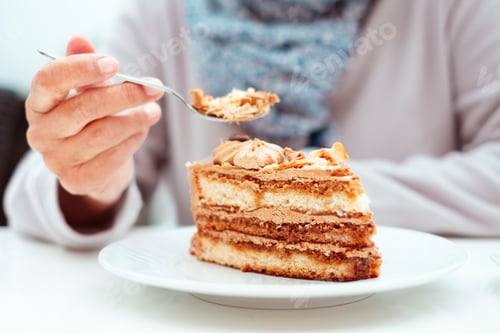 Preview: Woman sitting at the cafe table with a slice of coffee cake. Elderly woman ignoring the diet