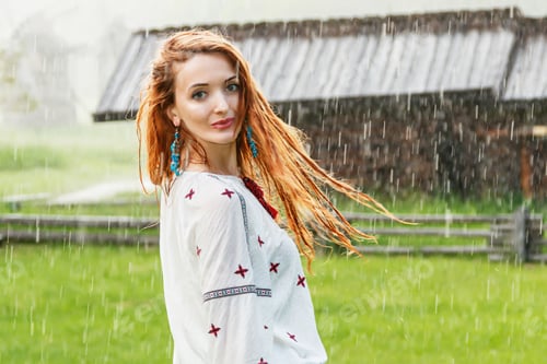 Preview: Beautiful girl with red hair dressed in embroidery (Ukrainian) in the rain