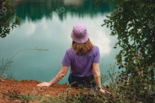 Preview: Woman traveler near lake in forest