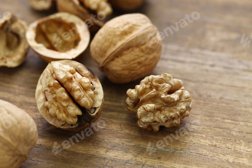 Preview: walnuts, kernel and shell on wooden background