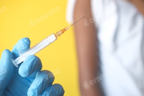 Preview: doctor hand in medical gloves holding syringe.