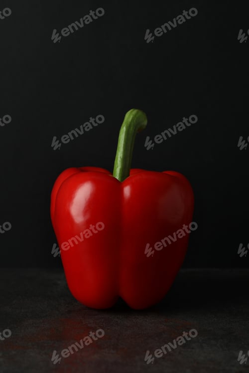 Preview: Red bell pepper on dark table, close up