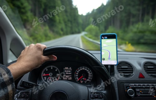 Preview: Navigator in the car on the road in a forest area, close-up.