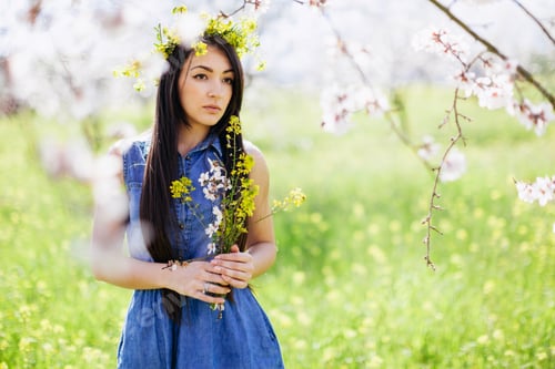 Preview: girl with flowers in spring blossom alley