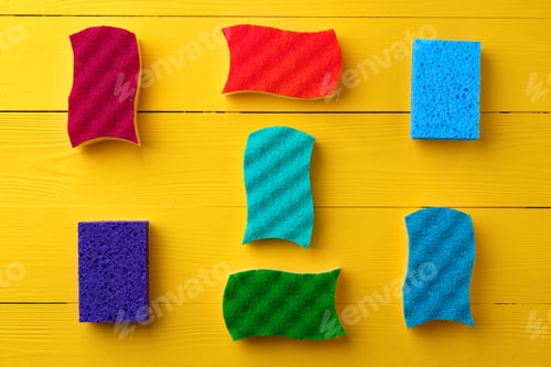 Preview: Cleaning sponges on yellow wooden background flat lay