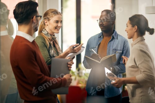 Preview: Happy creative woman talking with coworkers on business meeting in the office.