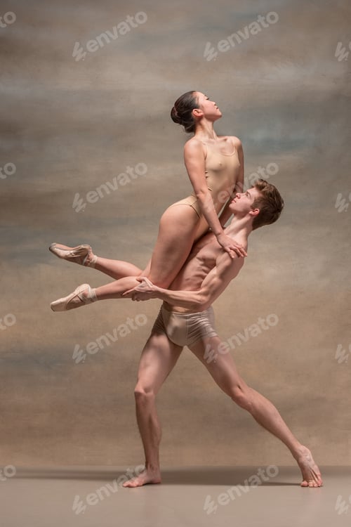 Preview: Couple of ballet dancers posing over gray background