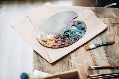 Preview: Paint Palette with Colorful Paints on Wooden Table