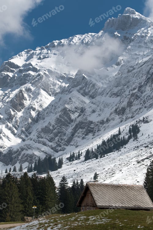 Preview: Scenic view of a wooden cabin against Santis mountain in Switzerland in winter