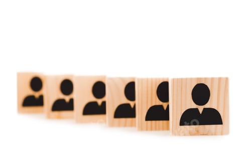 Preview: selective focus of wooden blocks with black human icons in row isolated on white