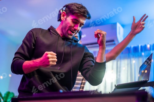 Preview: Asian young man artist DJ mixing and scratching music mixer controller.