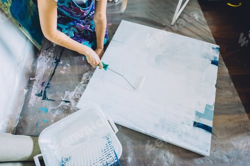 Preview: Close up hand painting canva with brush
