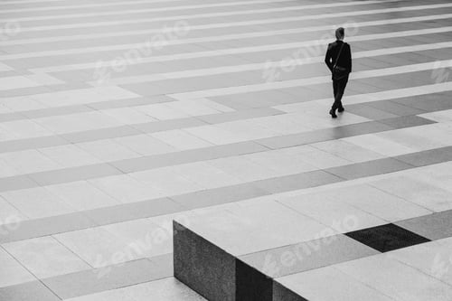 Preview: Businessman Walking Through a Stripped Floor