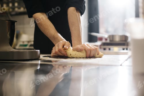 Preview: Close up. The cook kneads the dough with his hands, making macaroons or cakes.