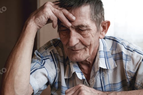 Preview: Senior sitting at the table and thinking about something or forg