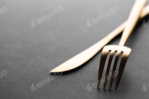 Preview: Gold cutlery set on black background