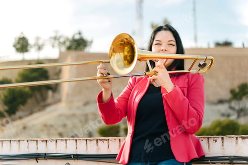 Preview: Young girl trombonist playing cheerful