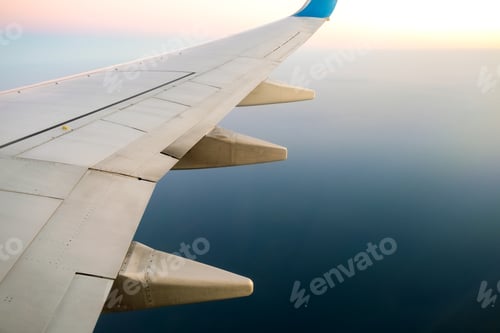 Preview: View from airplane on the aircraft white wing flying over ocean landscape