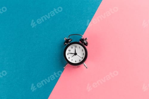 Preview: Vintage black alarm clock on a color block background