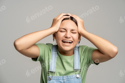 Preview: Happily smiling teenager with triumph face expression impressed by unbelievable news, great success