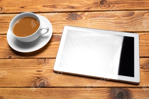 Preview: digital tablet and coffee cup on wooden table