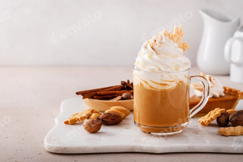 Preview: Pumpkin spice latte topped with whipped cream and cinnamon