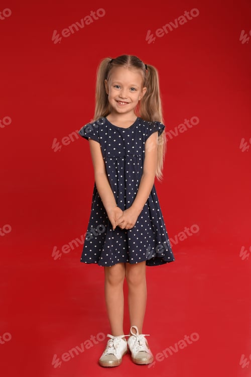Preview: Portrait of cute little girl on red background