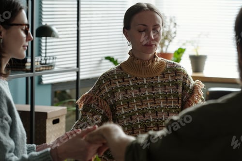 Preview: Woman Participating in Group Therapy Session Holding Hands